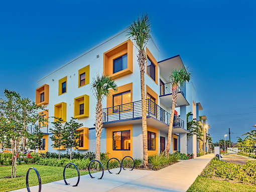 Corner view of the Gateway Luxury Apartments building, highlighting contemporary design and well-maintained landscaping.