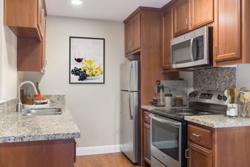 Apartments for Rent in Martinez CA - Mission Pines - Kitchen with Stainless Steel Appliances, Granite Countertops, and Wood-Style Cabinets