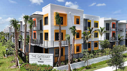 Exterior view of Gateway Luxury Apartments with clear property signage and contemporary building design.