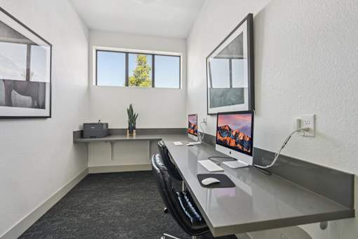 A modern office space with a desk, chair, and computer.
