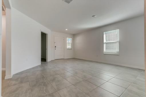 a large living room with a tiled floor