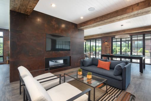 a living room with a gray couch and a fireplace