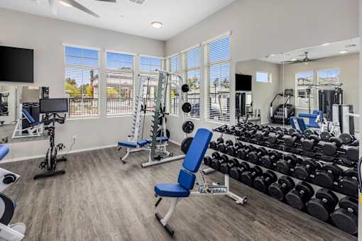 A spacious home gym with a variety of equipment.