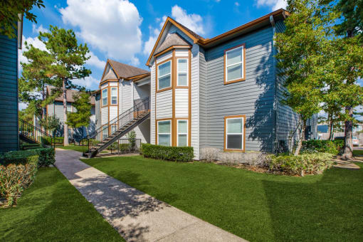 Outside of Breakwater Bay apartments with pathway for walking