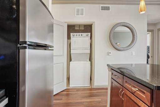 A modern kitchen with a stainless steel refrigerator and a white oven.