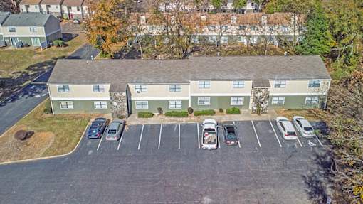 Element at 4411 Macon Apartments An aerial view of a parking lot with cars and apartment buildings.