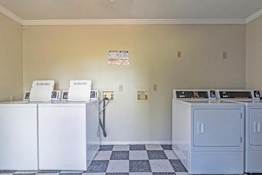 Element at 4411 Macon Apartments A laundry room with washers and dryers and a checkered floor.
