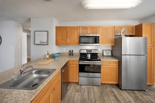 A kitchen with wooden cabinets and stainless steel appliances.