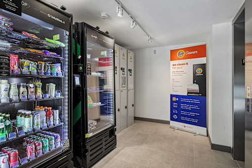 A vending machine with a variety of drinks and a sign that says "we clean it".