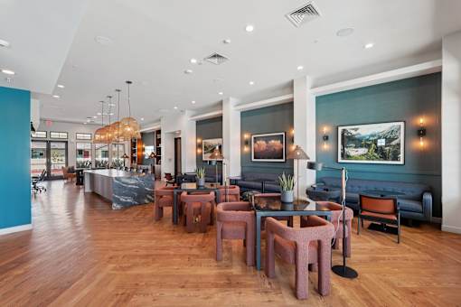 A large room with a long table and chairs.