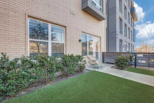 A building with a green lawn in front.