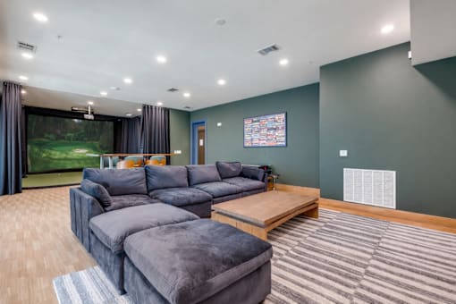 A living room with a grey sofa and a wooden coffee table.