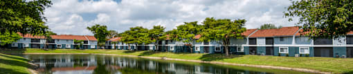 A row of houses with a body of water in front.