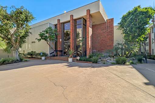 A modern building with a large front door and a brick facade.