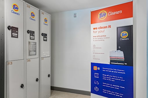 A Tide Cleaners display with a sign that says "we clean it for you!" and a picture of a shirt with a Tide logo on it.