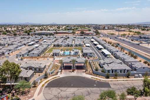 A large housing development with a central courtyard and a road running through it.