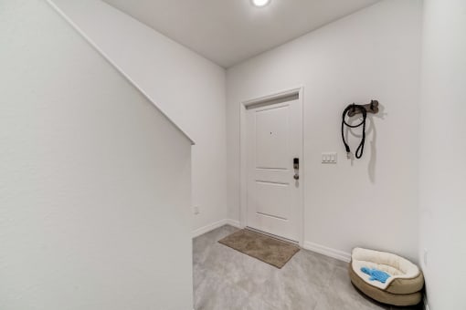 Boatman Hammock Townhomes in Lake Worth, FL photo of  the living room and entryway of a home with white walls and a white door