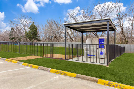 a bus stop with a fence and a toilet