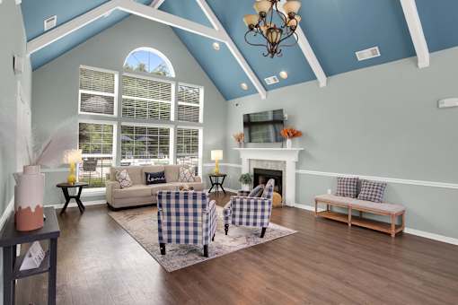 A living room with a fireplace and a checkered chair.