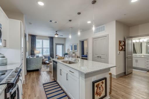 a kitchen with an island and a living room with a couch