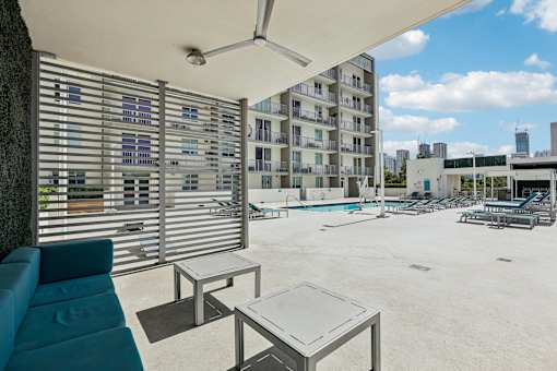 A patio area with a table and chairs and a pool table.