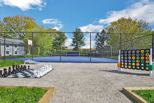 A playground with a chess set on the ground.