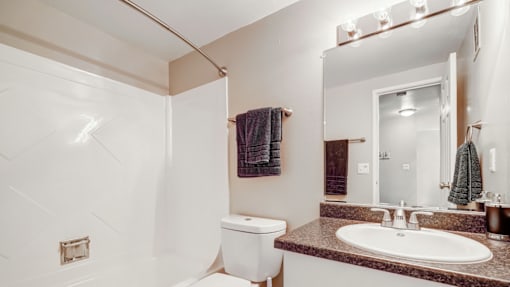 A white toilet sits next to a sink in a bathroom.