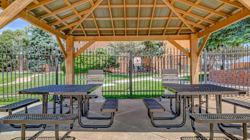 A covered picnic area with tables and benches.