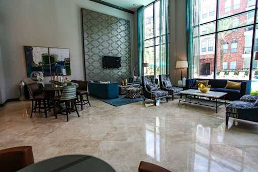 A living room with a large painting on the wall and a television.