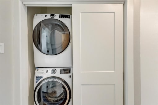 a front loading washer and dryer in a laundry room