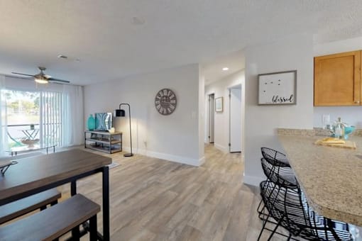 A kitchen with a dining table and chairs.