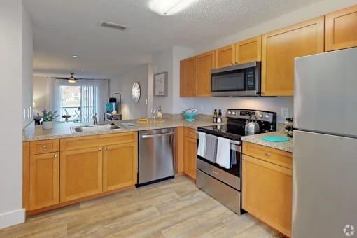 A kitchen with wooden cabinets and stainless steel appliances.