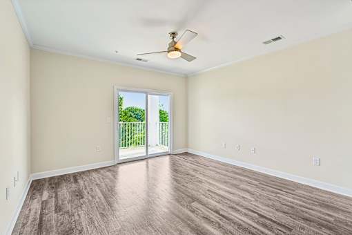 A bright Hawks Landing living space in Hickory NC featuring a sliding glass door that opens to a backyard