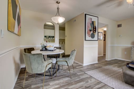 Derby Park Apartments in Daytona Beach, FL photo of an open living room and dining room with a table and chairs