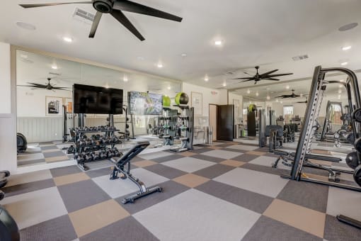  Denton, TX Houses For Rent - Carmel Villas - Spacious Fitness Center With Dumbells, Full Body Mirrors, Ceiling Fans, Workout Bench, Squat Rack, And Strength Training Machines