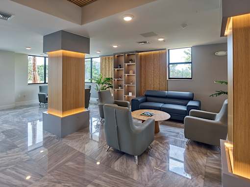 Gateway Luxury Apartments club room showcasing stylish seating arrangements and ambient lighting.