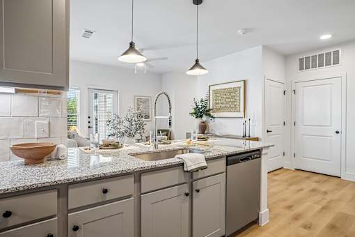 A modern kitchen with a granite countertop and a bowl on it.