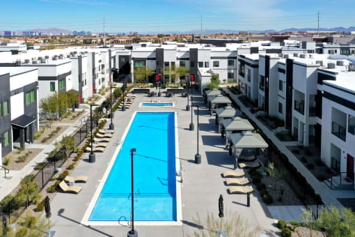 an aerial view of an apartment complex with a large swimming pool
