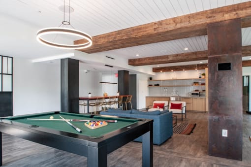 a game room with a pool table and a bar