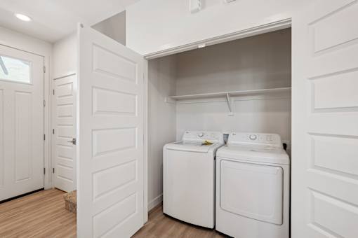 A small laundry room with a washer and dryer.