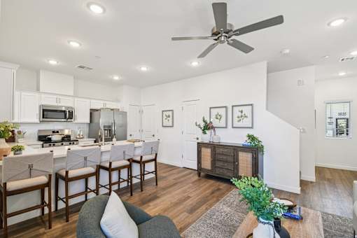 A modern kitchen with a dining table and chairs.