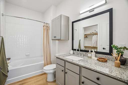 A bathroom with a white toilet, a white sink, and a white bathtub.