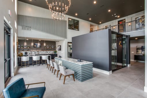 a large room with a bar and chairs in front of it