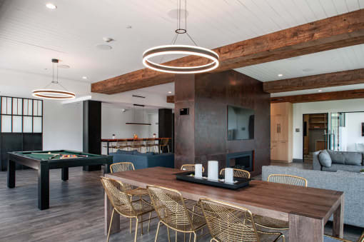 a dining room with a table and a pool table