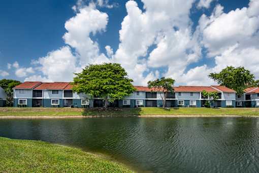 A row of houses with a body of water in front.