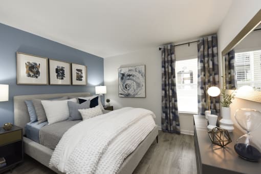 a bedroom with blue and white walls and a bed with pillows