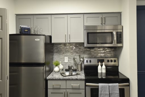 a kitchen with stainless steel appliances and a granite counter top