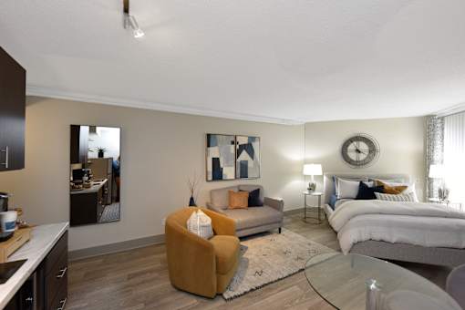 A modern bedroom with a large bed and a yellow armchair.