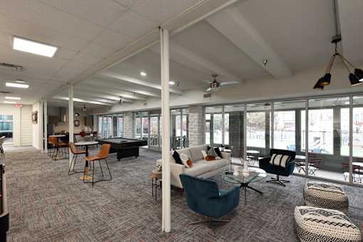 A spacious room with a long table and chairs.