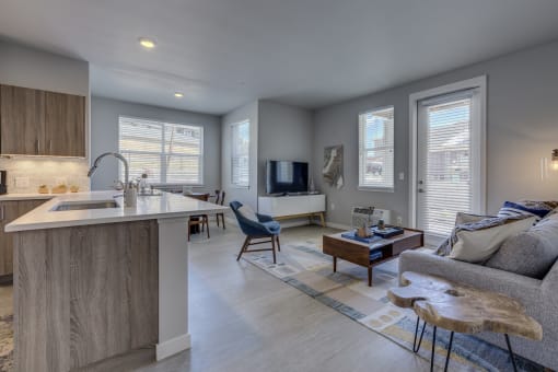 a kitchen and living room with a couch and a coffee table